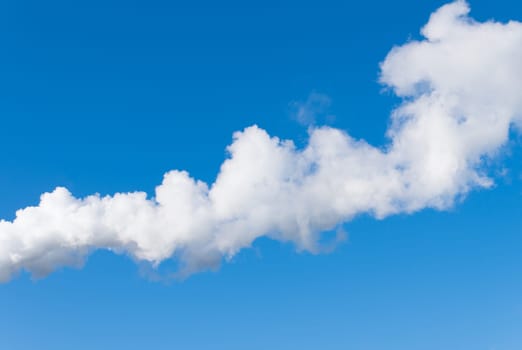 line of white smoke against a blue sky