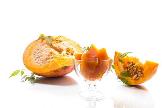 Prepared sweet pumpkin marmalade in a glass bowl isolated on a white background. Autumn recipes.