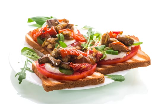 Prepared sandwich with tomatoes, mozzarella and fried eggplant with mushrooms in a plate isolated on white background.