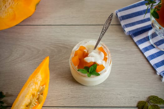 Homemade yogurt with pieces of pumpkin marmalade. Autumn recipes.
