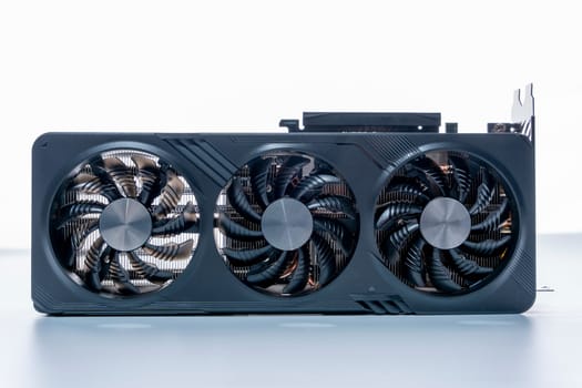 a modern powerful gaming graphics card for a computer with three fans. the concept of PC hardware. Gaming video card