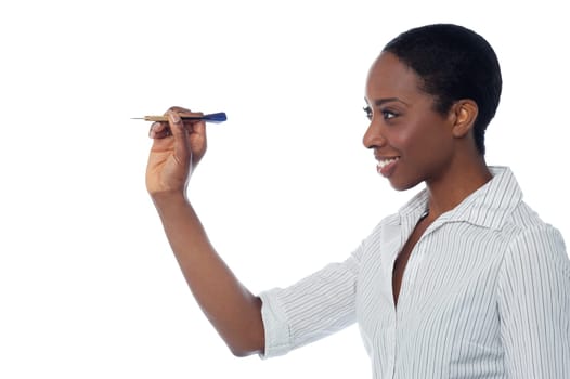 Confident businesswoman throwing dart