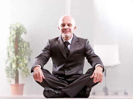 meditating Relaxed businessman smiling with his eyes closed