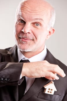 real estate seller smiling at you because he's sure you can afford it