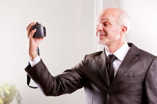 Businessman taking a selfie with his digital camera