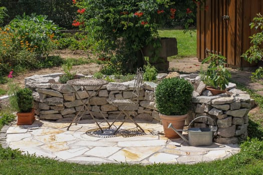 Seat in the garden with herb bed