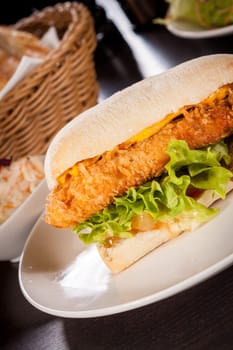 Chickenburger with chicken meat and salad as a close-up on a plate