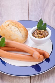 hot wiener sausage with mustard and fresh dark farmer's bread