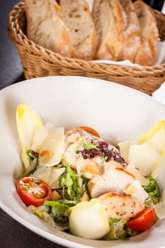 Fresh delicious caesarsalat with grilled chicken bust parmesan splinters and croutons