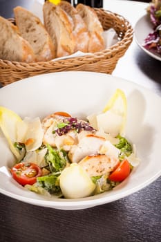 Fresh delicious caesarsalat with grilled chicken bust parmesan splinters and croutons