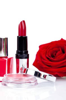 lipstick nail polish and rouge detail shot with red rose cosmetic makeup beauty