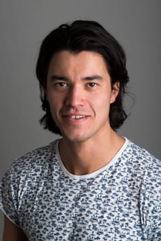 Portrait of handsome Malaysian man wearing flowery top and smiling