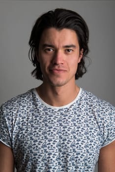 Portrait of handsome Malaysian man wearing flowery top and smiling