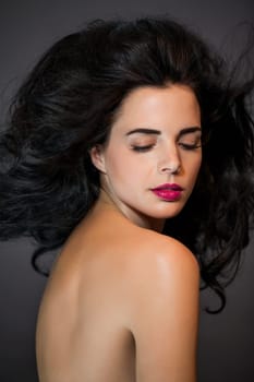 young attractive woman with red lips and dark curly hair with lots of volume portraitboy attractive woman with red lips and dark curly hair with lots of volume portrait