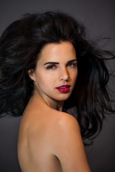 young attractive woman with red lips and dark curly hair with lots of volume portraitboy attractive woman with red lips and dark curly hair with lots of volume portrait