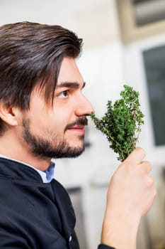 young chef in the restaurant kitchen with fresh arümatic spices