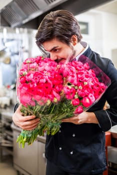 young chef with red roses in the hand table decoration romantik dinner restaurant