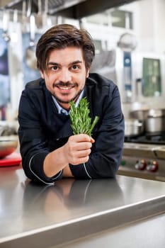 young chef in the restaurant kitchen with fresh arümatic spices