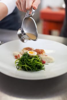 gourmet food with scallops and quail eggs and puree prepared with sauce
