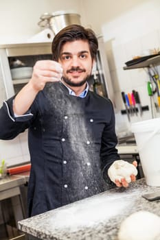 young chef throwing dough pizzadough pizza baker in the restaurant kitchen