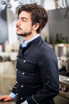 young adult chekoch in the restaurant kitchen at the herd while cooking