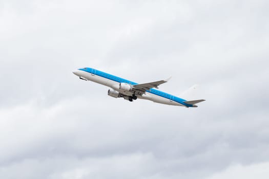 large passenger plane in the air before blue sky holiday travel transport