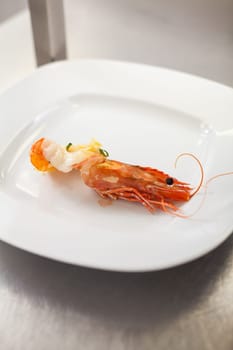 chef prepares fresh pasta spaghetti with shrimp crusts on a plate at the restaurant