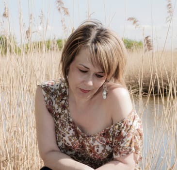 high key outdoor portrait of woman at side of lake