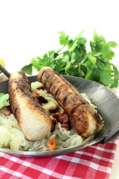 a pan with sauerkraut and roast sausage