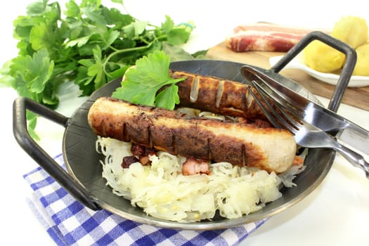 a pan with sauerkraut and roast sausage