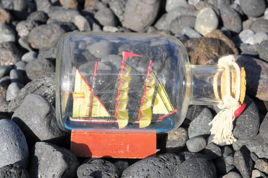 Ancient Spanish Sailing Boat in a Bottle near the Ocean