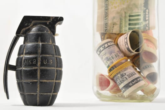 Money for War Concept Hand Grenade and banknotes