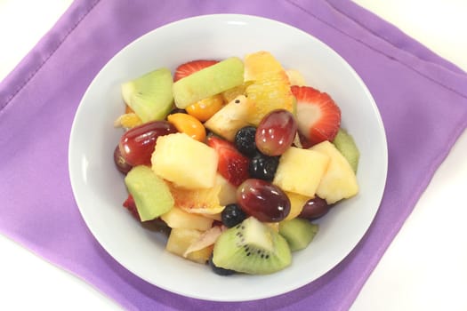 a white bowl with fresh fruit