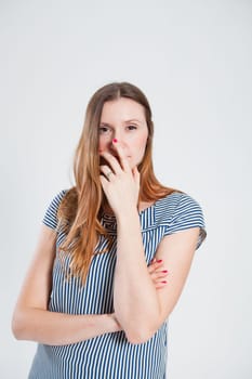 Studio portrait of relaxed attractive and stylish woman touching lower part of face with hand