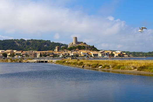 View on the little medieval village Gruissan with its castle ruins in the center