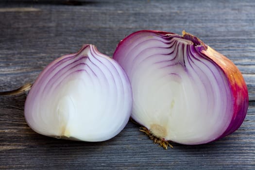 Close up view of fresh red onions on a old wooden Table