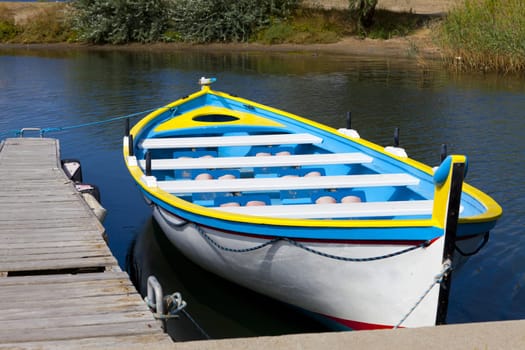Colourful rowing boat to a jetty in Gruissan in southern France