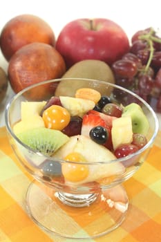a cocktail bowl with fresh fruit salad