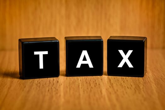 Tax accounting text on black block , business concept