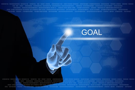 business hand pushing goal button on a touch screen interface