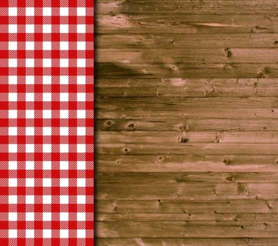 Wooden background and tablecloth with red and white plaid