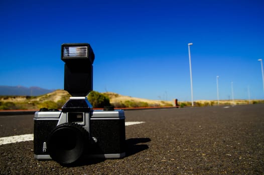 Street Photography Concept Vintage Camera on the Asphalt