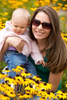 Mother and daughter in flowers
