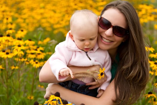 Beautiful smiling mother holding daughter