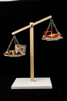 Money and Toy Wooden Car on a Two Pan Balance
