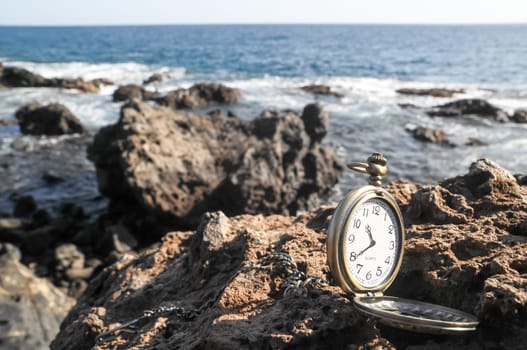 Time Concept Classic Vintage Pocket Clock on the Volcanic Rocks