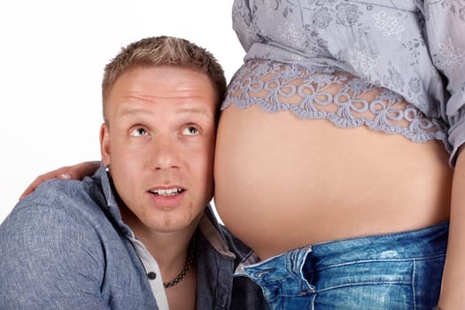 Father-to-be hears at baby belly