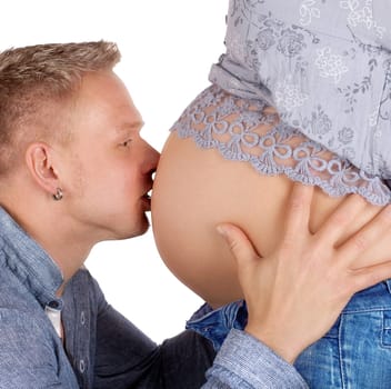 Father-to-be kisses baby belly
