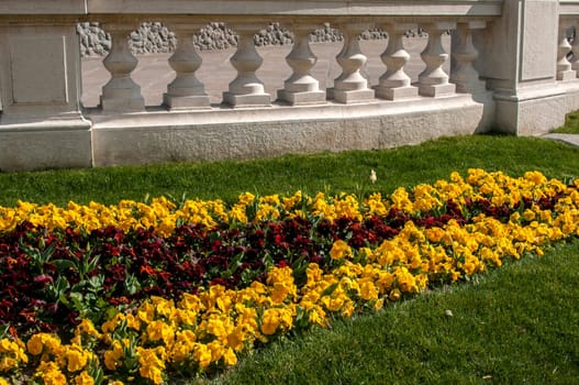 Flower bed and white stone fence in park