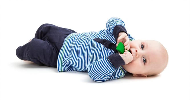 vertical image of lying toddler on floor. isolated on white background